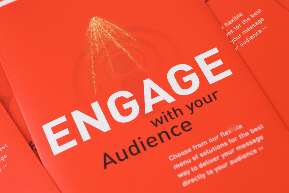 Real Estate Social Media Strategies. Ottawa Realtor, Anna Alemi Real Estate Team. A red promotional brochure with bold white and black text that reads "ENGAGE with your Audience."