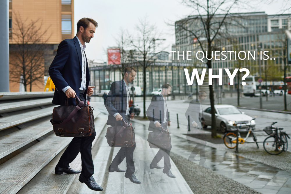 Realtors leaving brokerage. Best Realtor in Ottawa, Canada. Anna Alemi Real Estate Team. Businessman in a suit walking down city steps with a leather briefcase, shown in multiple faded motion silhouettes along a wet street, with overlaid text that reads ‘THE QUESTION IS… WHY?’ on the right side.