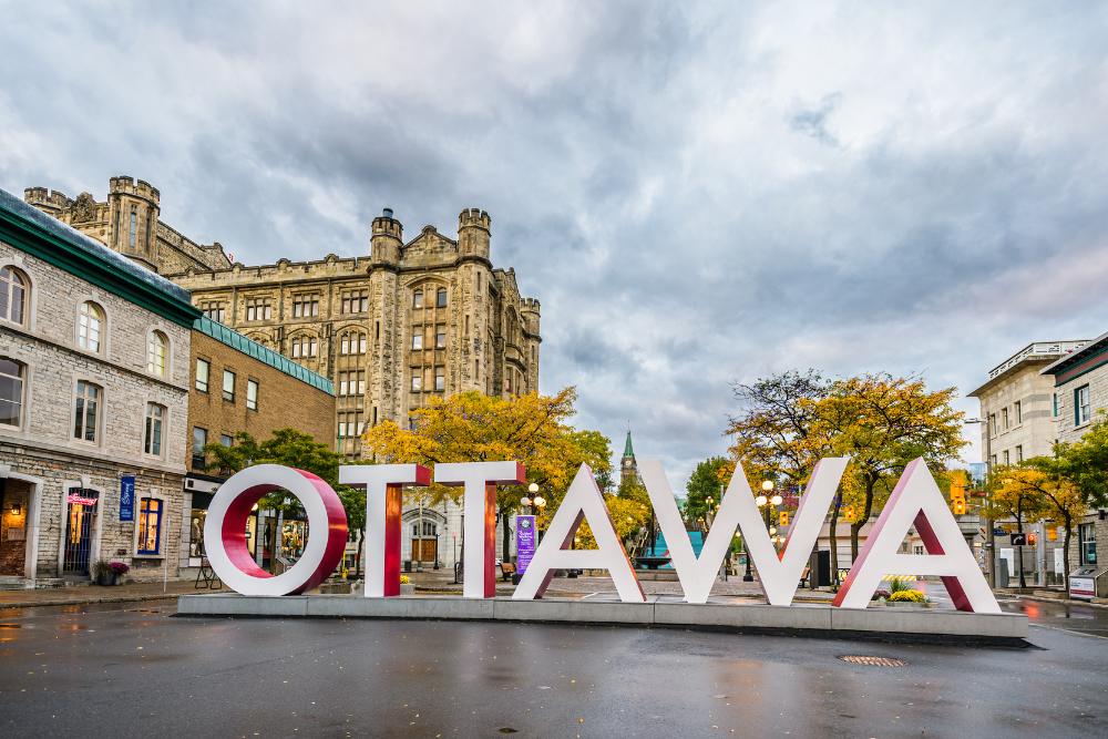 Ottawa homebuyer exploring neighborhoods near the iconic Ottawa sign in ByWard Market. Anna Alemi Real Estate.