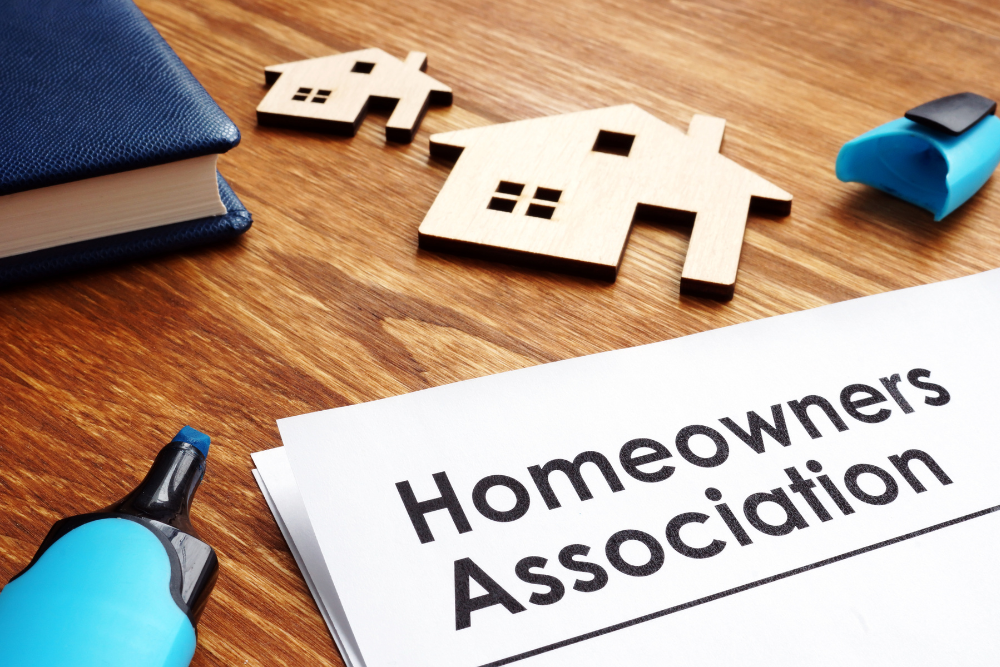 Canadian homeowners reviewing housing market documents with home models on desk – Anna Alemi real estate insights