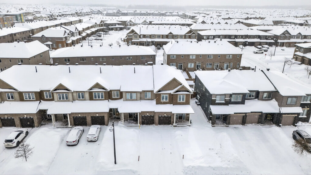 Aerial winter view of the neighborhood near 367 Mountain Sorrel Way in Orléans Ottawa, showing snow-covered townhomes in a quiet residential community. Anna Alemi Real Estate.