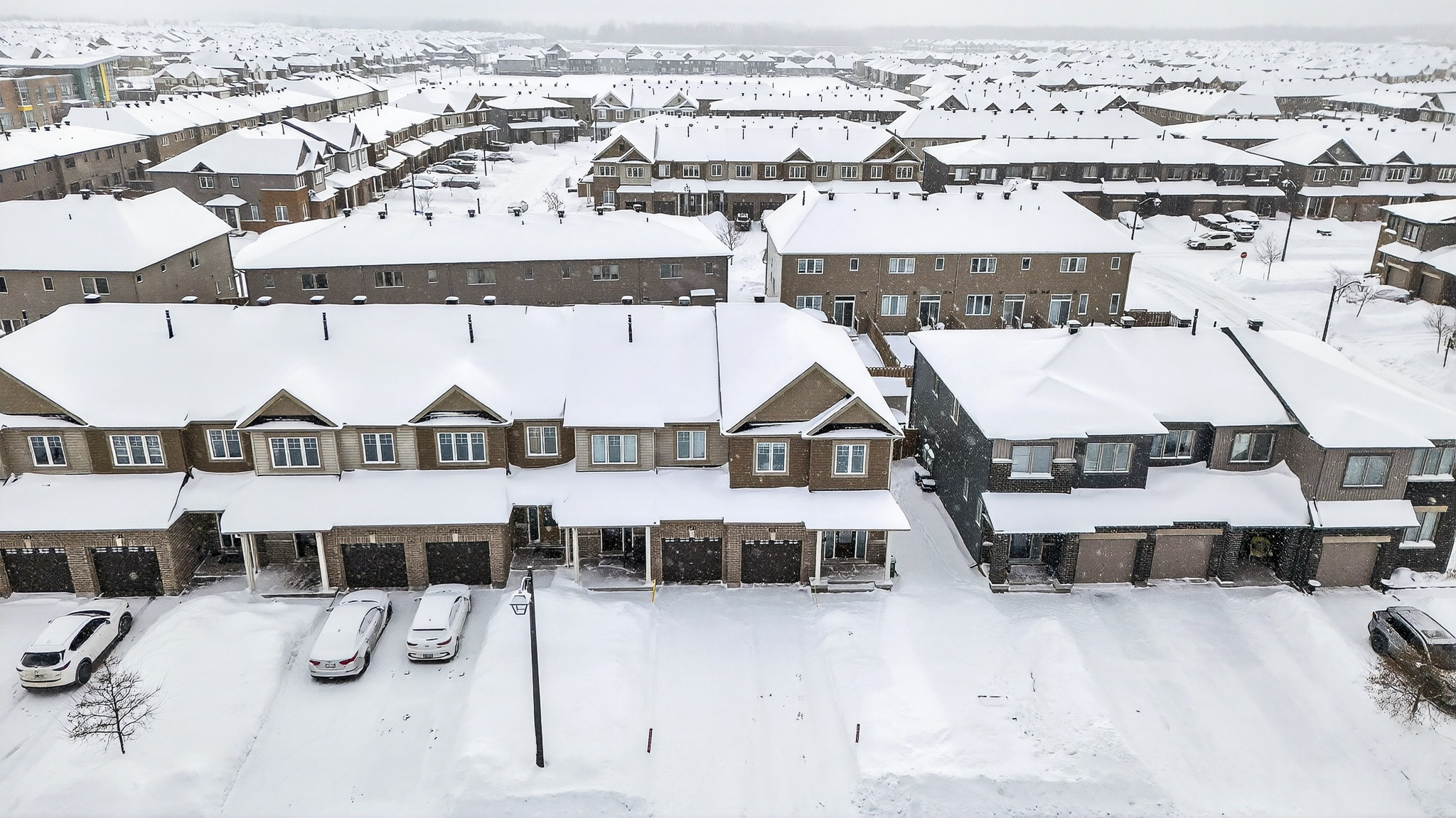 Aerial winter view of the neighborhood near 367 Mountain Sorrel Way in Orléans Ottawa, showing snow-covered townhomes in a quiet residential community. Anna Alemi Real Estate.