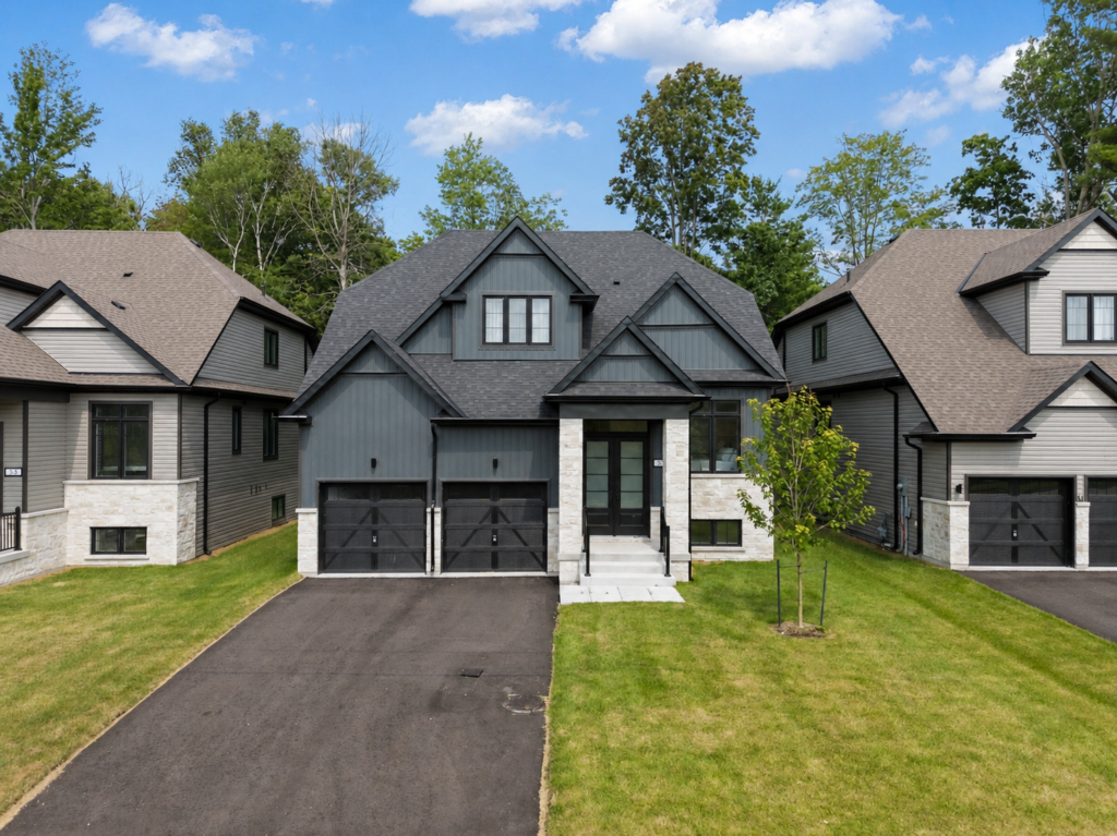 Modern 4-bedroom bungalow with upper loft, double garage, and landscaped front yard in Wasaga Beach near Beach Area 1