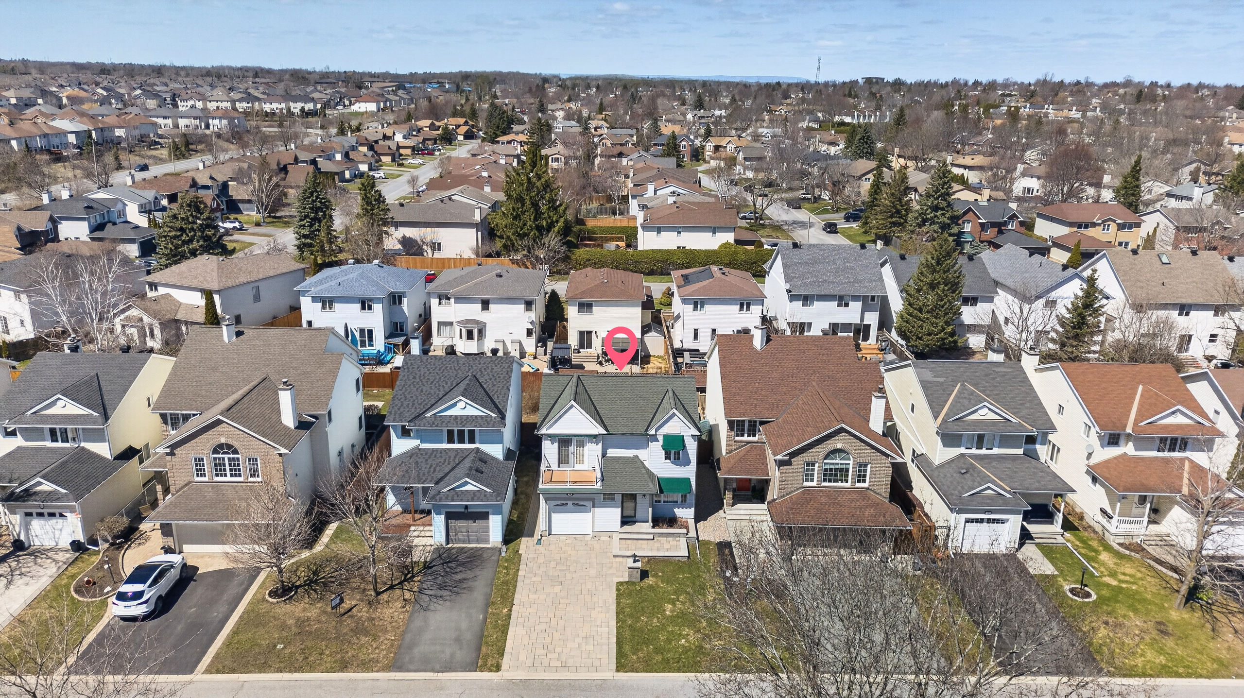 Aerial view of 30 Peacock Crescent in Barrhaven, Ottawa, showcasing the family home within the established Cedargrove neighbourhood with nearby residential homes.